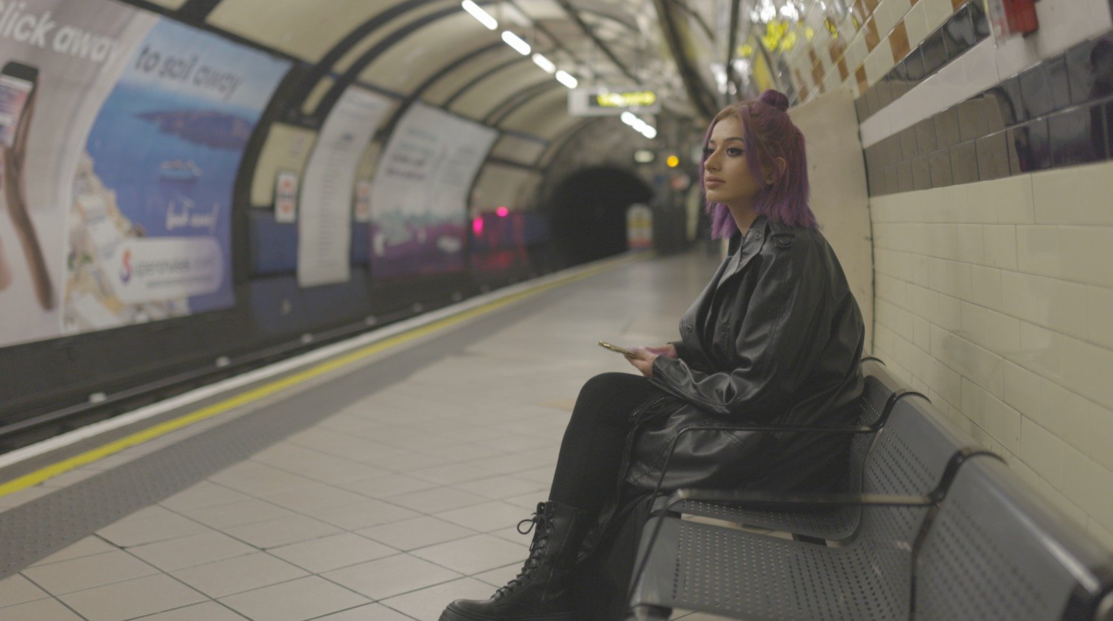 A nurse waiting on an Underground platform, from A Passion for Nursing